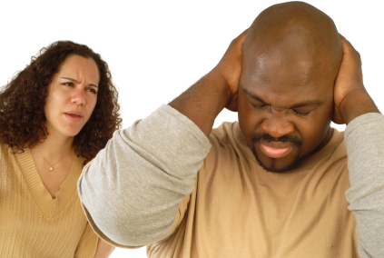 Man shutting his ears and not listening to the persistent yelling of his spouse